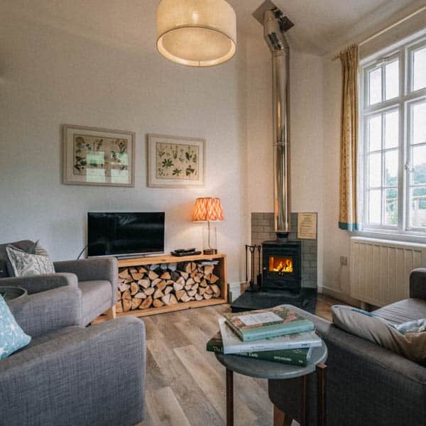 Contemporary living room with a wood-burning stove in the Dounebrae apartment at Douneside