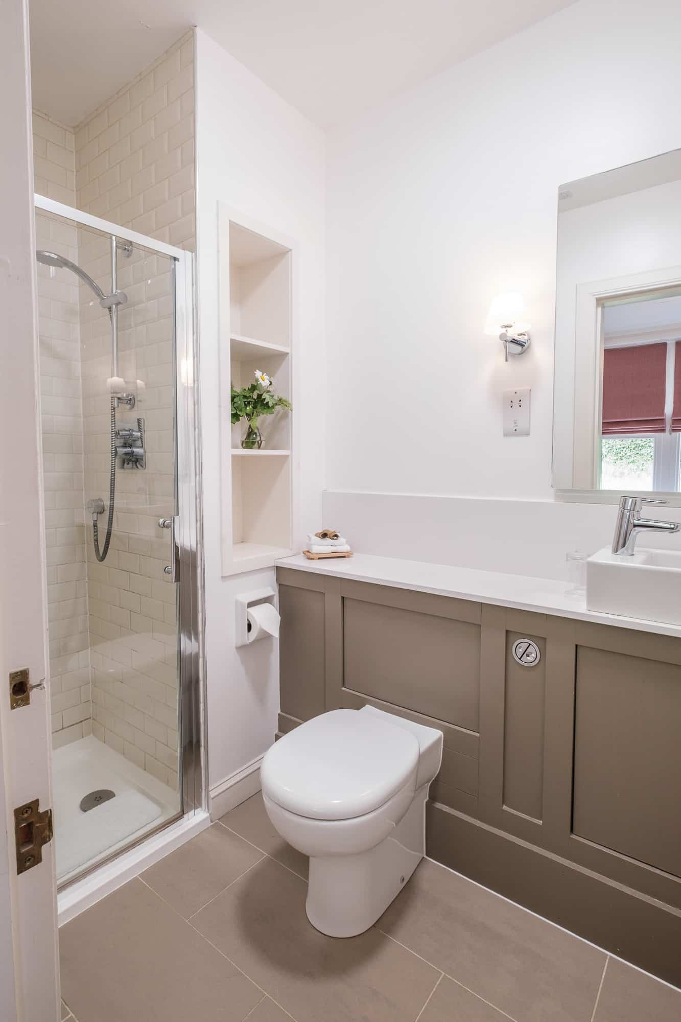 Second bathroom in Gatehouse with vessel basin, walk-in shower and chrome wall lights at Douneside House