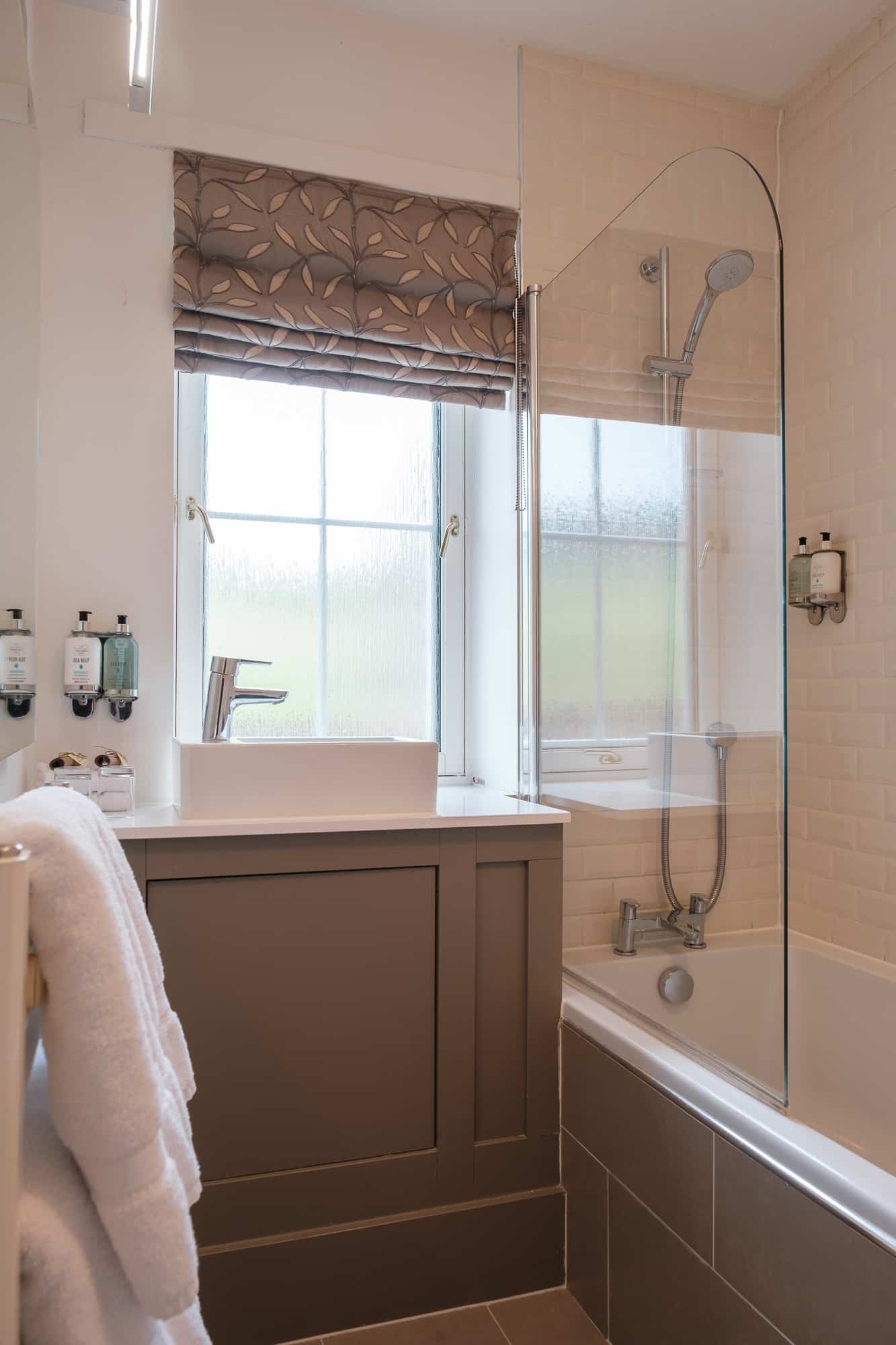 Bathroom_Alpha_Cottage Un suite Bathroom in Alpha Cottage with bath, shower and Sea Kelp toiletries at Douneside House
