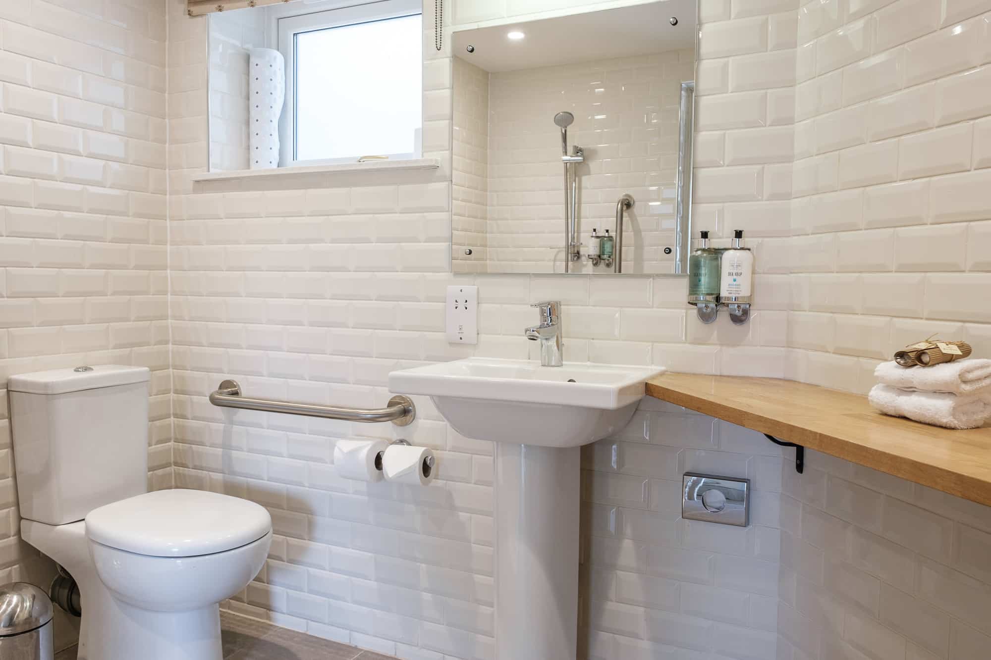 Bathroom in Casa 22 with walk-in shower, metro tiles and Sea Kelp toiletries at Douneside House