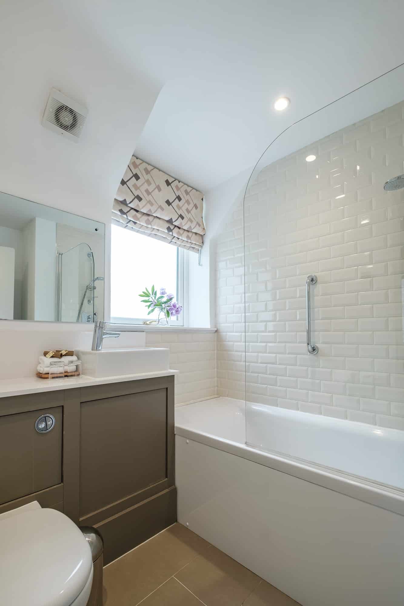 Bathroom in Casa 24 with over-bath shower, metro tiles and vessel basin at Douneside House