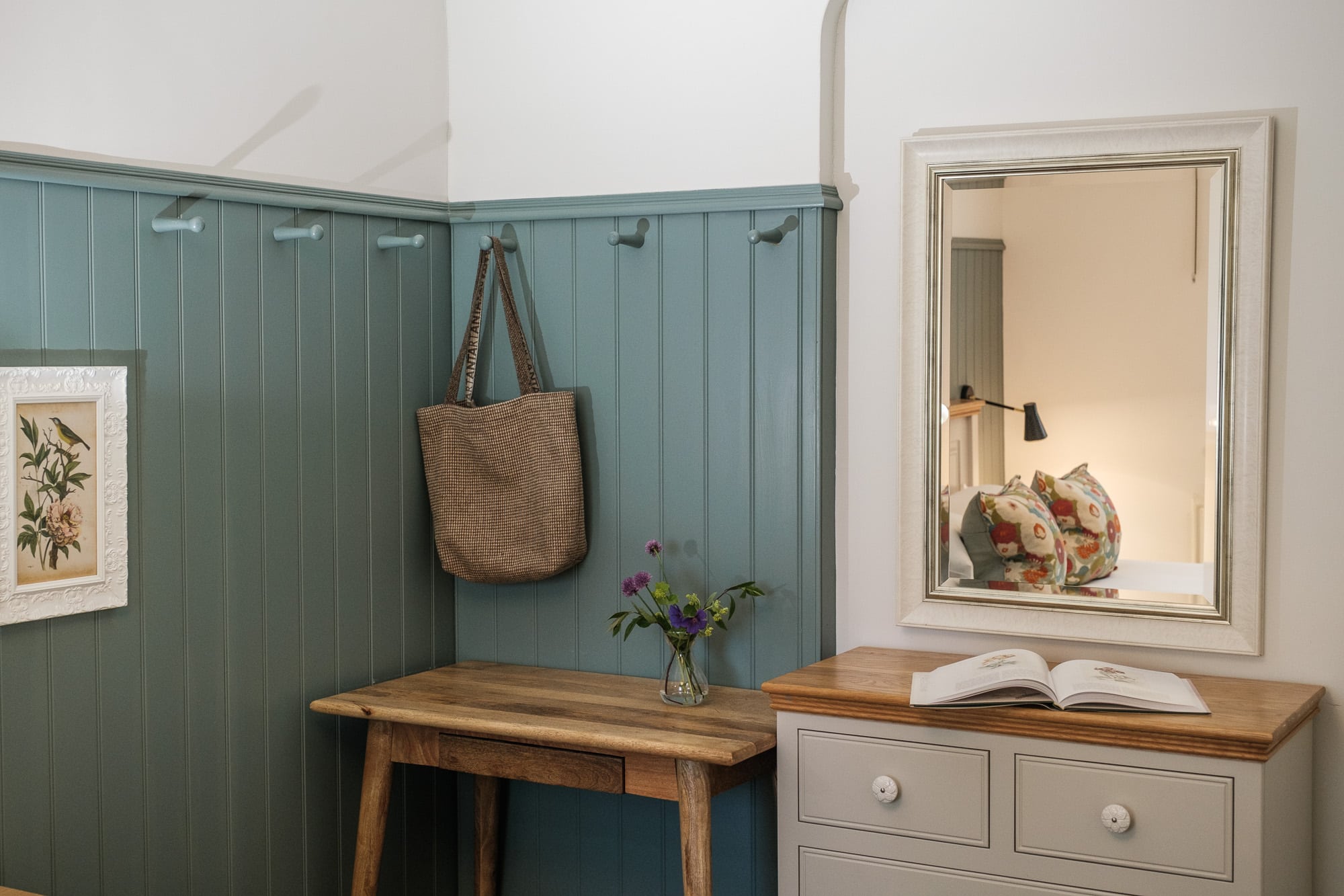 bag hanging up in Casa 23 bedroom with a dressing area and mirror at Douneside House Estate