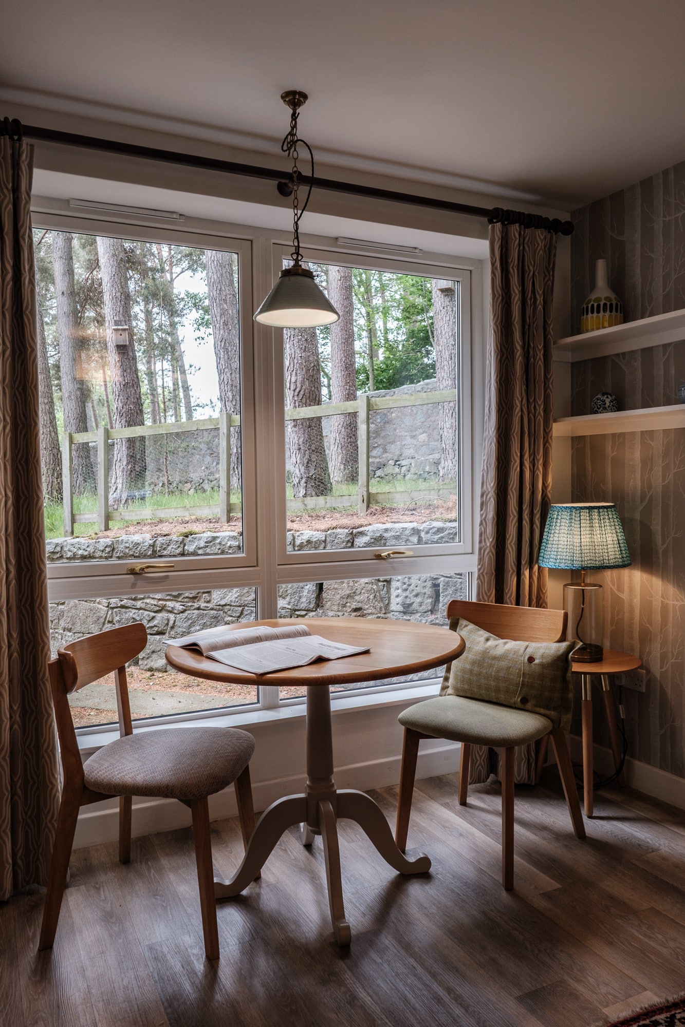 Casa 23 Dining area with view out onto pine trees at Douneside House apartments