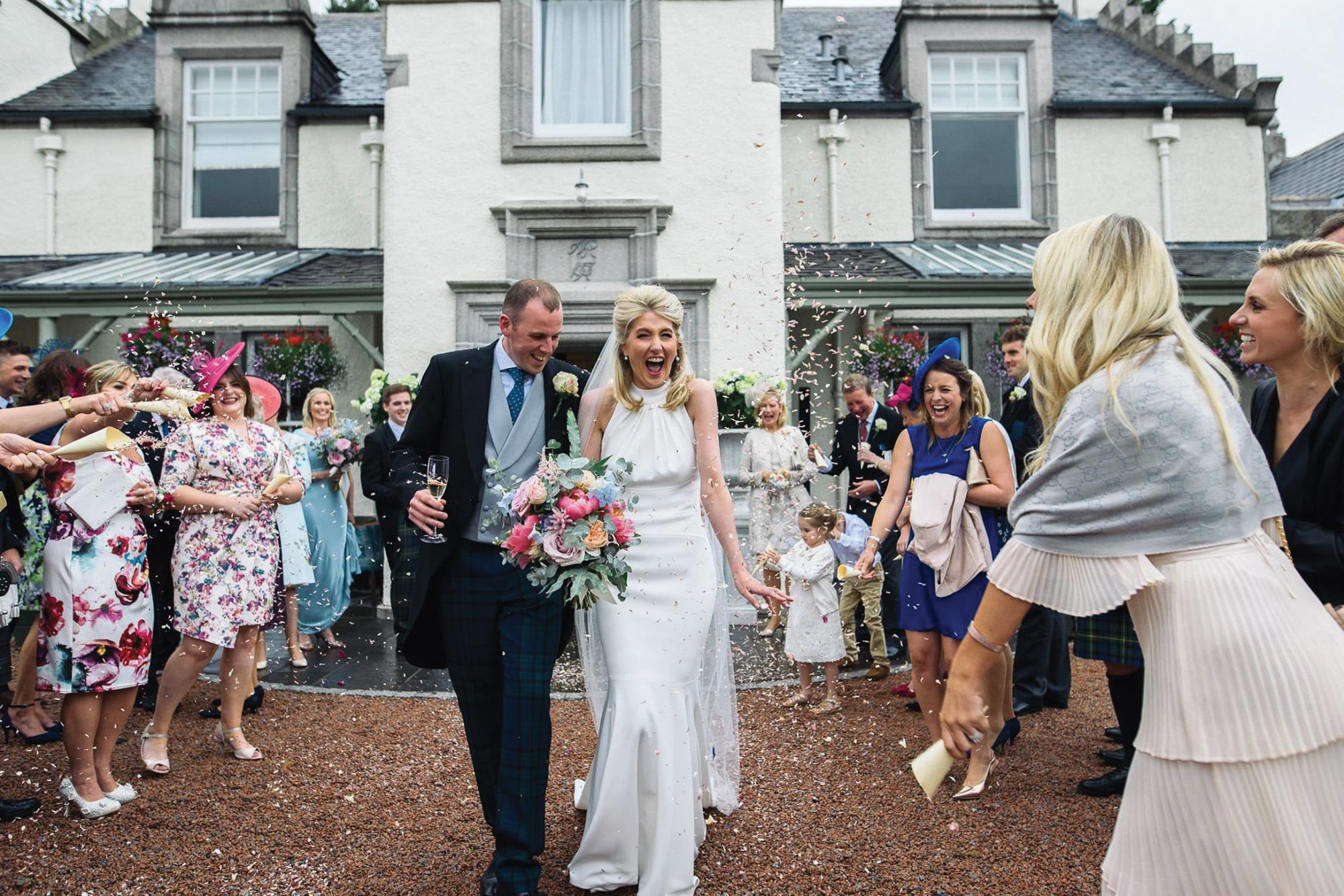 Confetti throw at Douneside House wedding Couple at Douneside House getting confetti thrown at them by guests