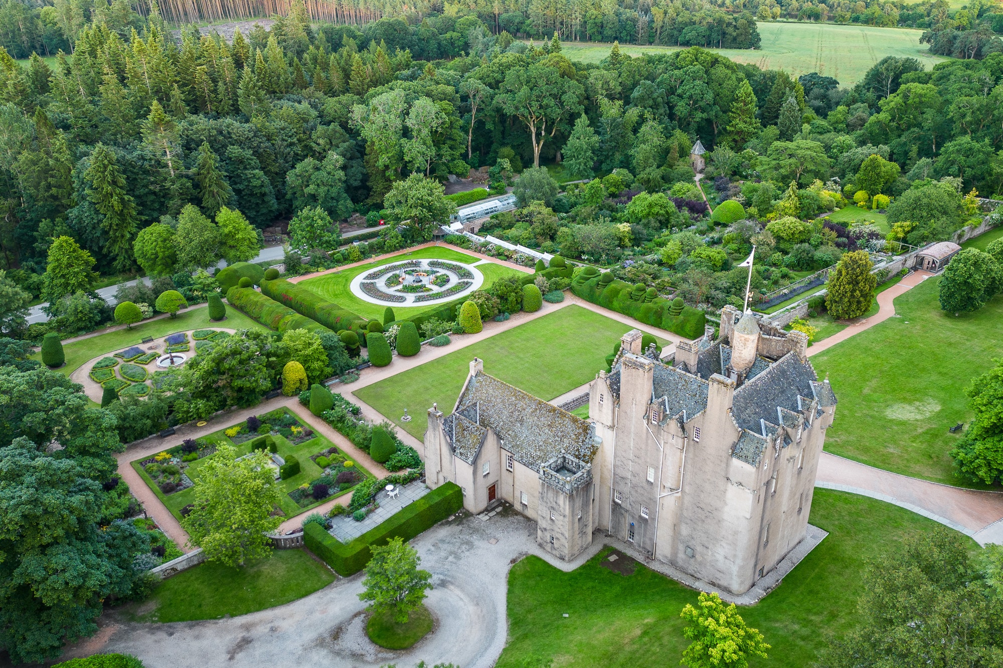 Aerial view of Crathes Castle surrounded by its formal gardens in Royal Deeside, Aberdeenshire