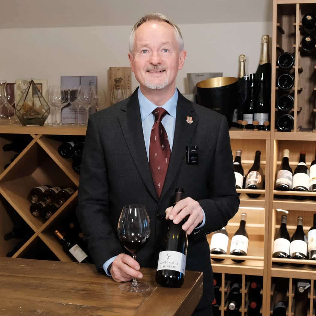 Member of the Douneside House sommelier standing behind the bar
