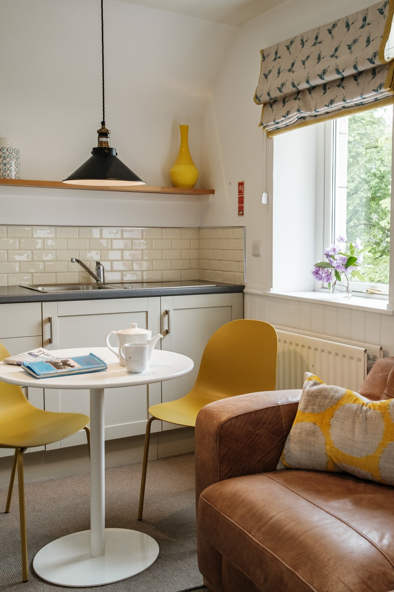 Casa 24 dining detail with branded Douneside House mug, teapot and wildflowers