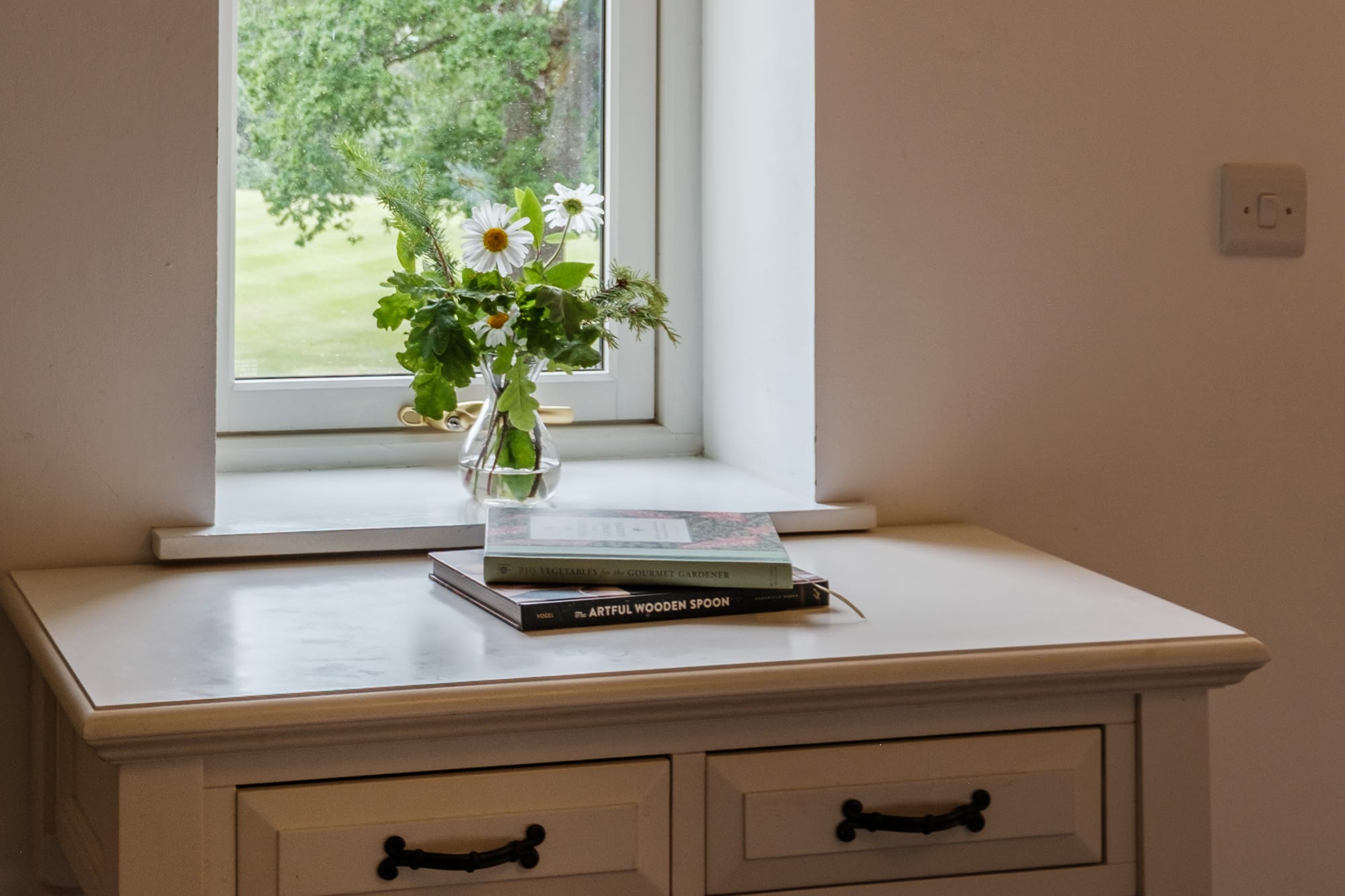 Dresser_Casa_21 Casa 21 bedroom detail with white dresser, wildflowers and garden view at Douneside House