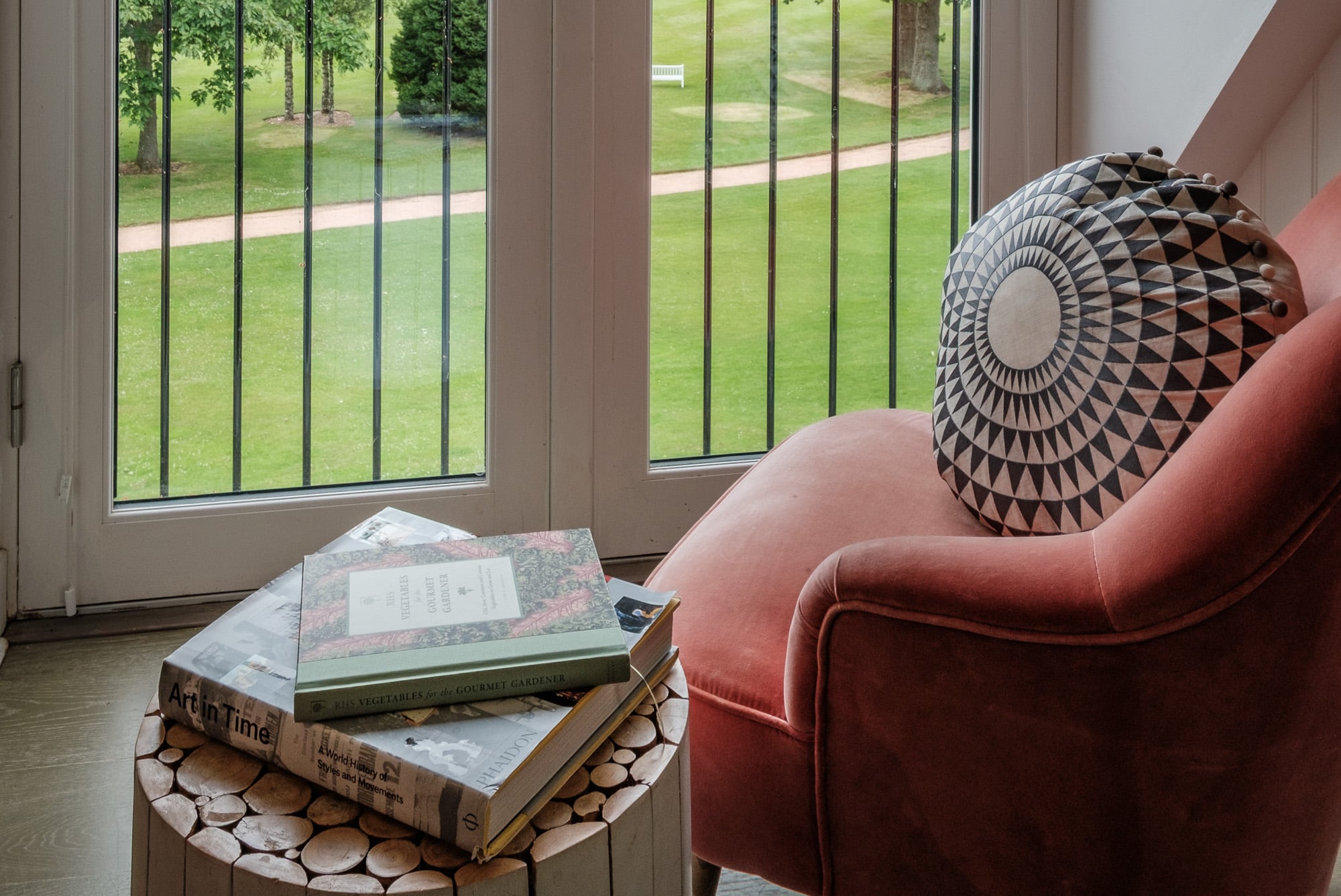 Reading_Nook_Casa_21 Reading nook in Casa 21 with pink velvet chair, geometric cushion and lawn view at Douneside House