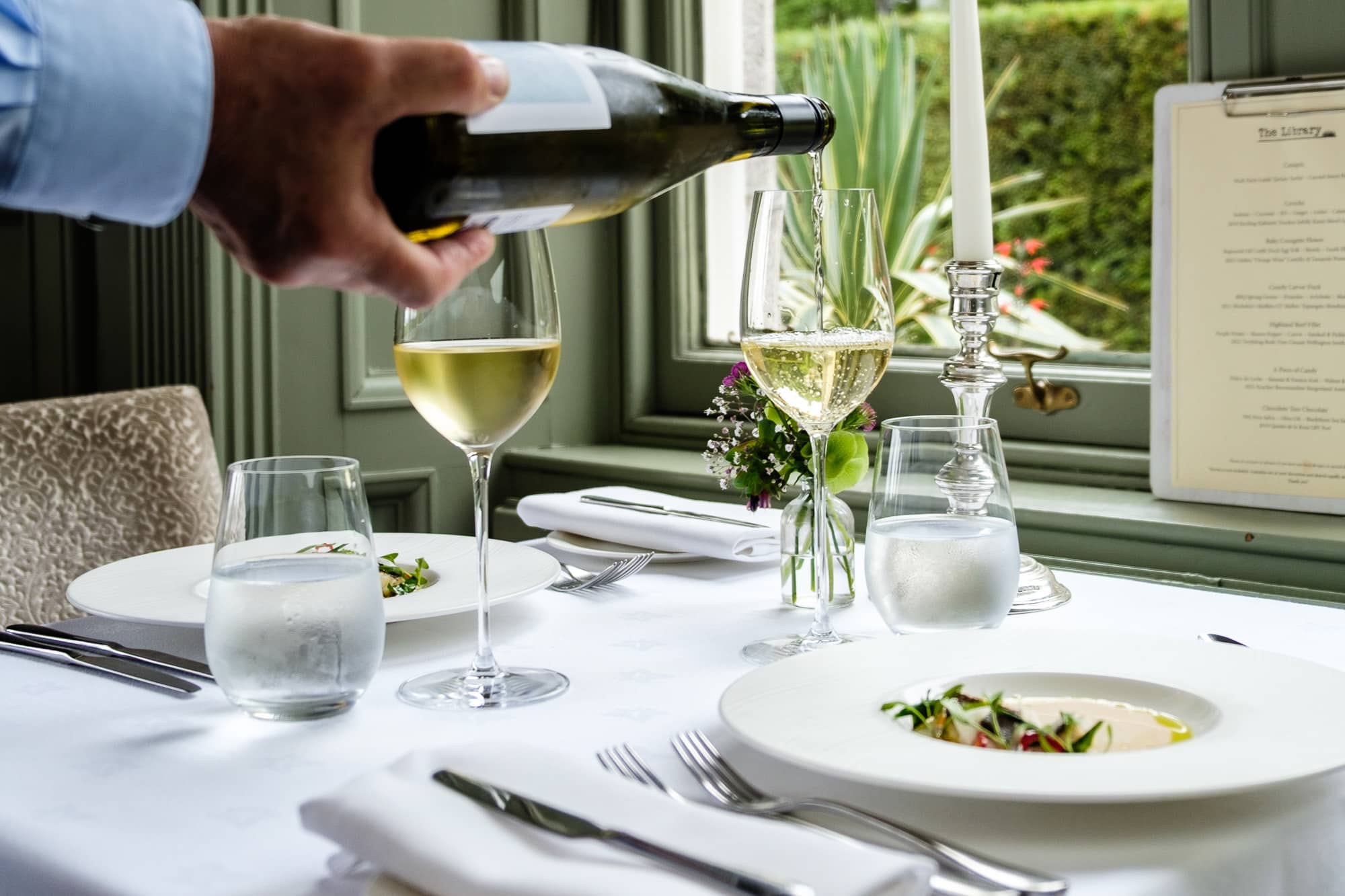 Wine poured with diner at the Douneside House Library Restaurant
